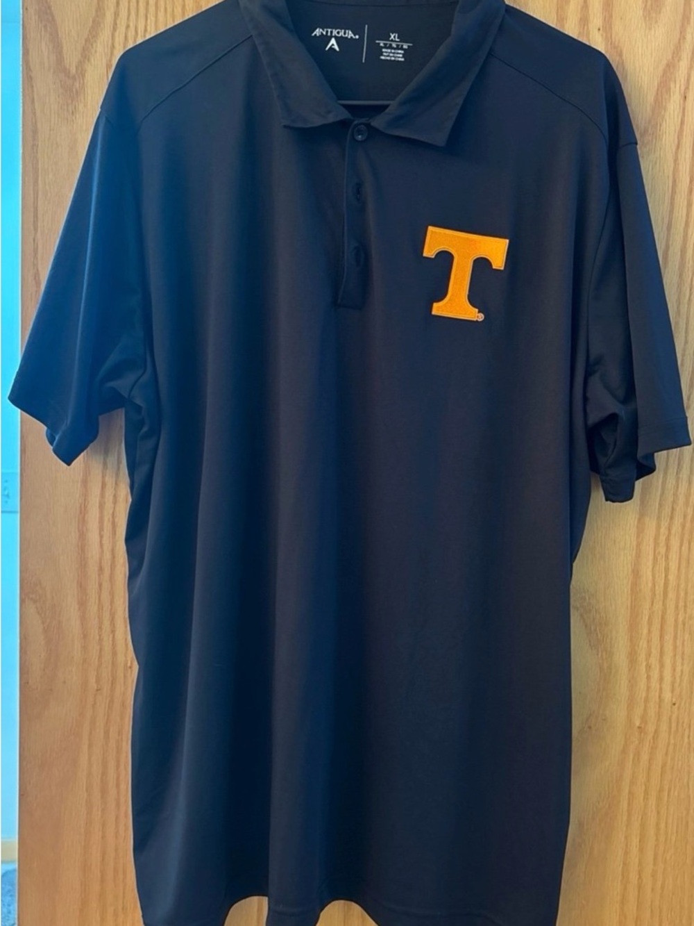 Antigua Men’s Black Polo with Orange 'T' Emblem